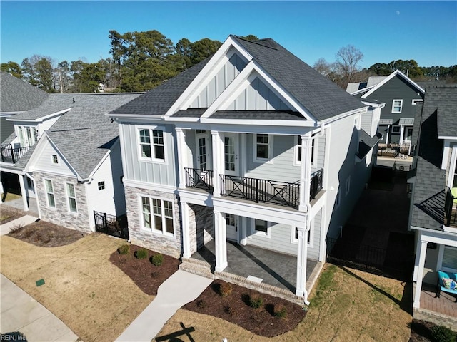 view of front of home featuring a front yard and a balcony