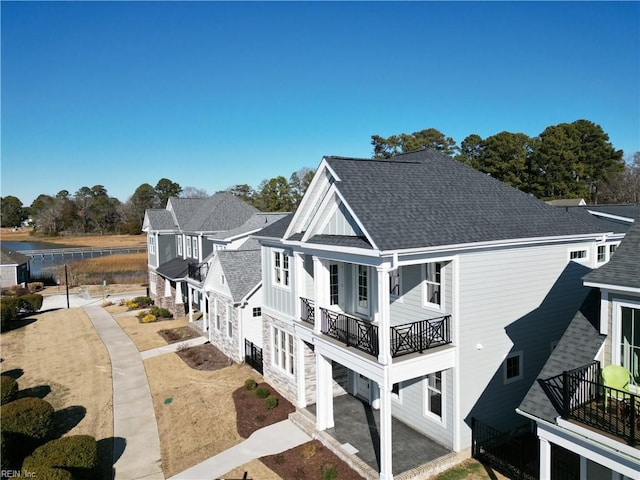 view of side of property featuring a balcony