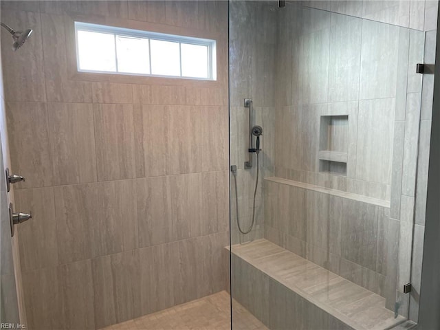 bathroom featuring a tile shower