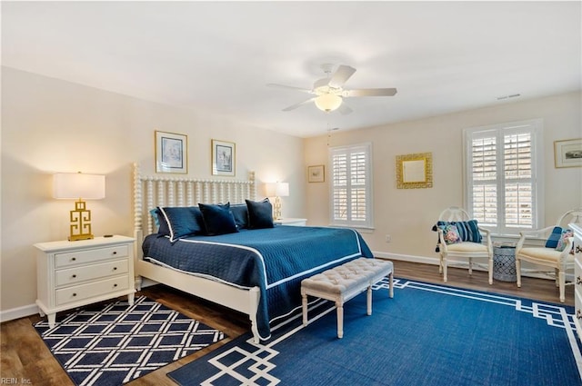 bedroom with dark hardwood / wood-style floors and ceiling fan