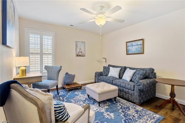 living room with dark wood-type flooring and ceiling fan