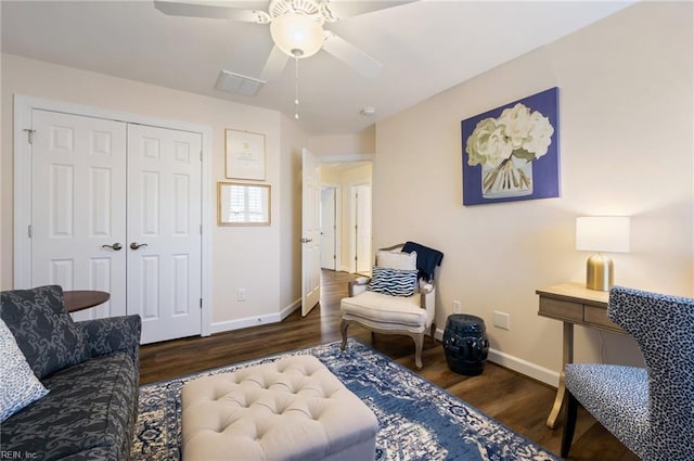 sitting room with ceiling fan and dark hardwood / wood-style flooring