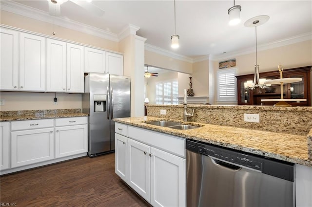 kitchen featuring sink, ceiling fan, appliances with stainless steel finishes, hanging light fixtures, and white cabinets