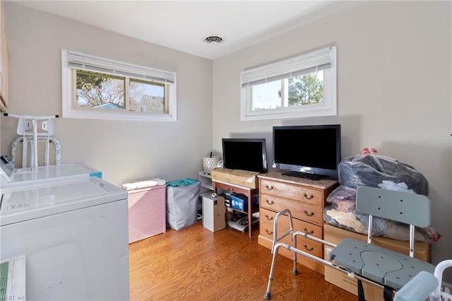 interior space featuring independent washer and dryer and light hardwood / wood-style flooring