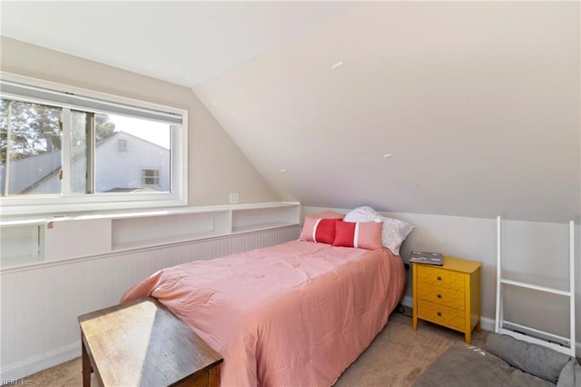 bedroom featuring lofted ceiling and carpet flooring