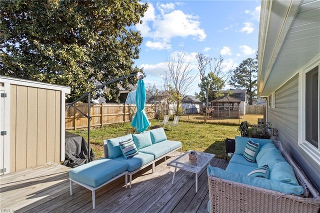 wooden deck with a yard and an outdoor living space with a fire pit