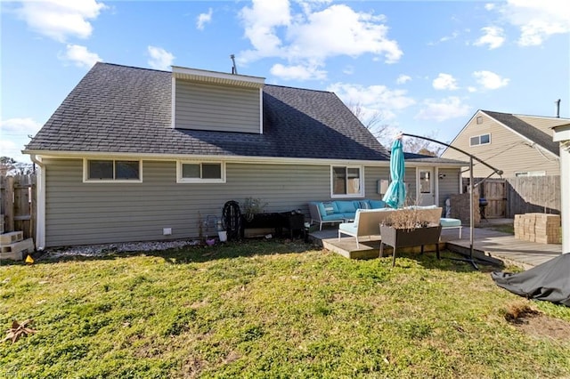 back of house with an outdoor living space and a yard