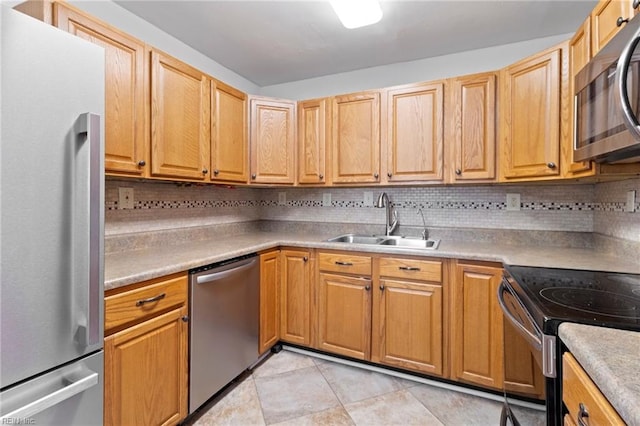 kitchen featuring tasteful backsplash, stainless steel appliances, sink, and light tile patterned floors