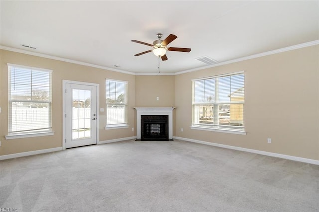 unfurnished living room with crown molding, light carpet, and ceiling fan