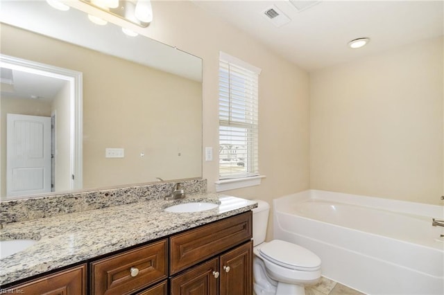 bathroom featuring vanity, a bath, tile patterned floors, and toilet