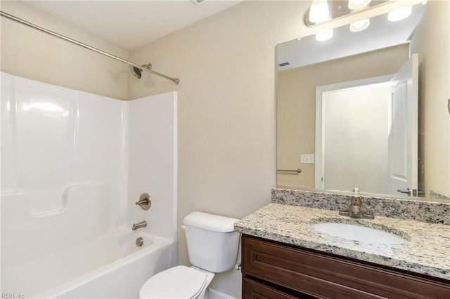 full bathroom with vanity, washtub / shower combination, and toilet