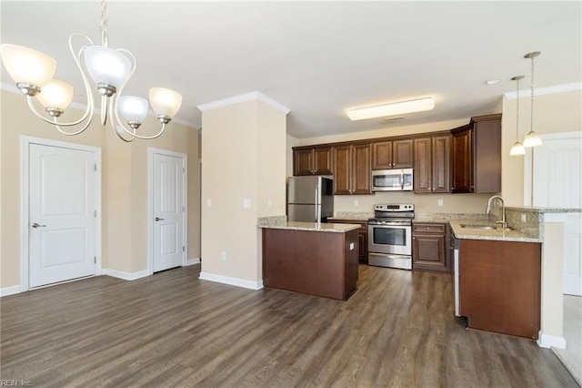 kitchen with ornamental molding, appliances with stainless steel finishes, decorative light fixtures, and sink