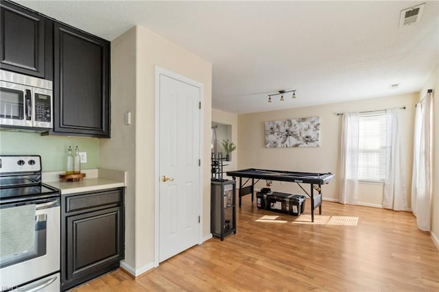 kitchen featuring light hardwood / wood-style flooring and appliances with stainless steel finishes