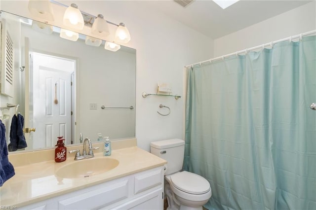 bathroom featuring vanity, walk in shower, and toilet