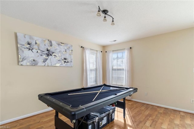 rec room with hardwood / wood-style flooring, pool table, and a textured ceiling