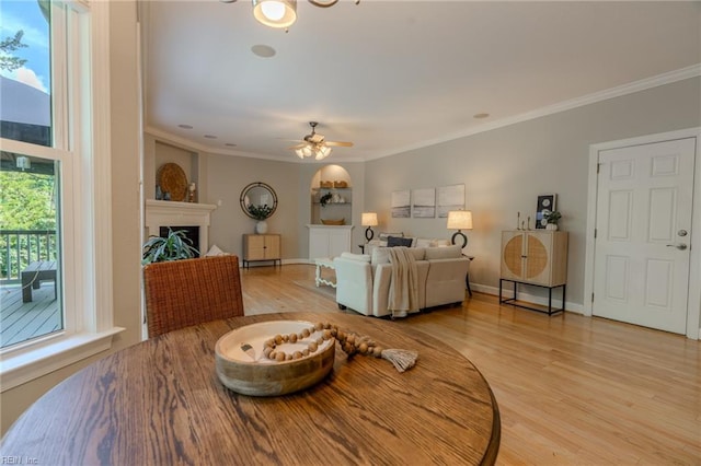 living room featuring hardwood / wood-style floors, ornamental molding, and ceiling fan