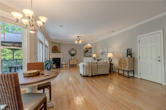 living room with ceiling fan with notable chandelier, light hardwood / wood-style flooring, and ornamental molding