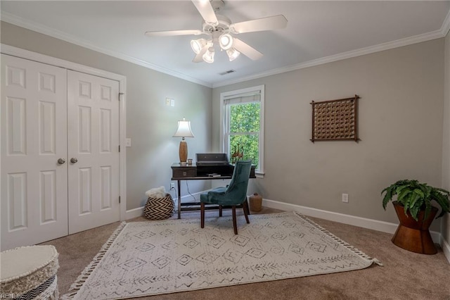 carpeted office space featuring crown molding and ceiling fan