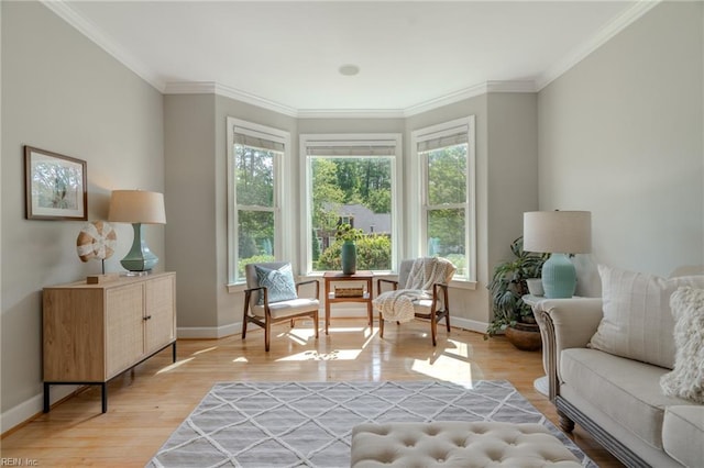 sitting room with ornamental molding, plenty of natural light, and light hardwood / wood-style floors