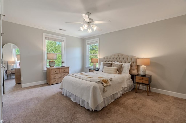 carpeted bedroom with crown molding and ceiling fan