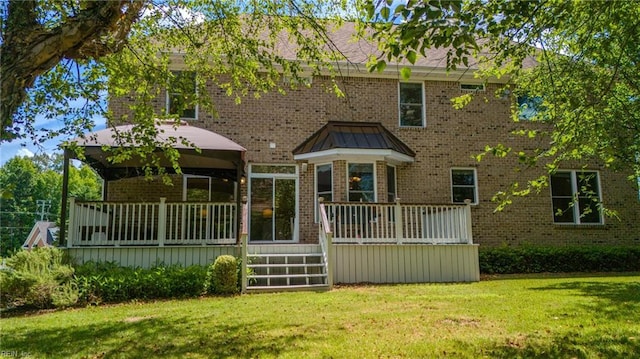 rear view of property with a gazebo and a lawn