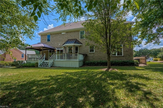 back of house featuring a gazebo, a wooden deck, and a yard