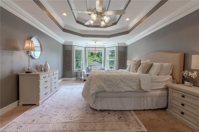 carpeted bedroom with crown molding, ceiling fan, and a tray ceiling