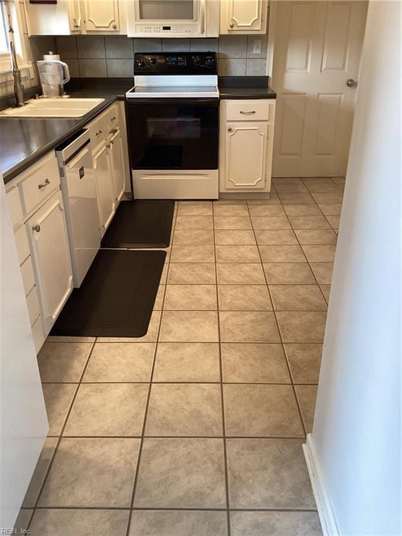 kitchen with white cabinetry, white appliances, and light tile patterned flooring