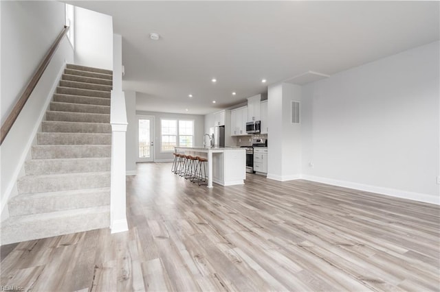 unfurnished living room featuring light hardwood / wood-style floors