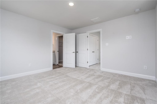 unfurnished bedroom featuring light colored carpet