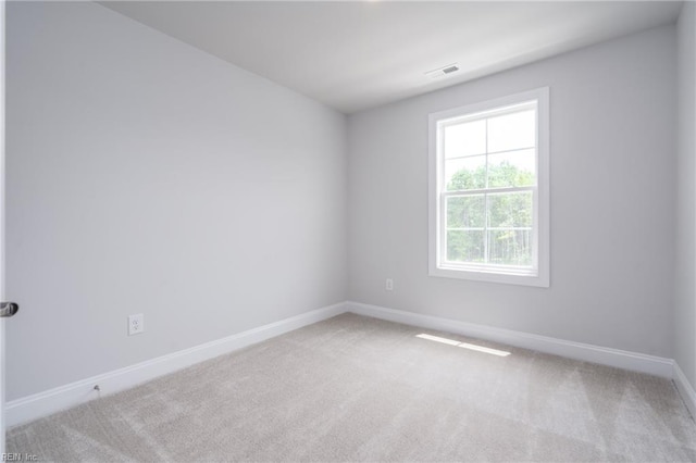 empty room featuring light colored carpet