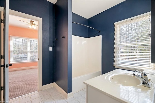 bathroom with bathing tub / shower combination, sink, tile patterned floors, and ceiling fan