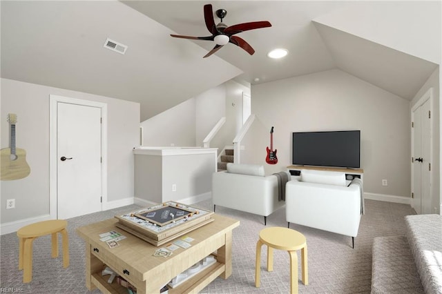 carpeted living room featuring vaulted ceiling and ceiling fan