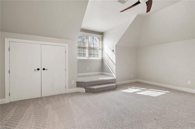 bonus room with vaulted ceiling, ceiling fan, and carpet