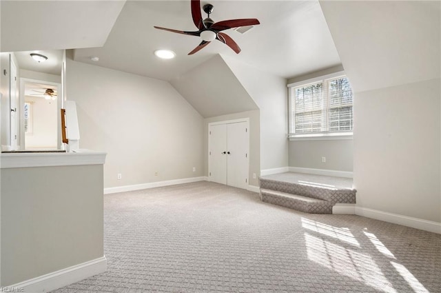 bonus room featuring lofted ceiling, carpet flooring, and ceiling fan