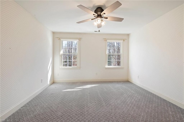 spare room with light colored carpet and ceiling fan