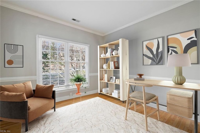 living area with crown molding and wood-type flooring