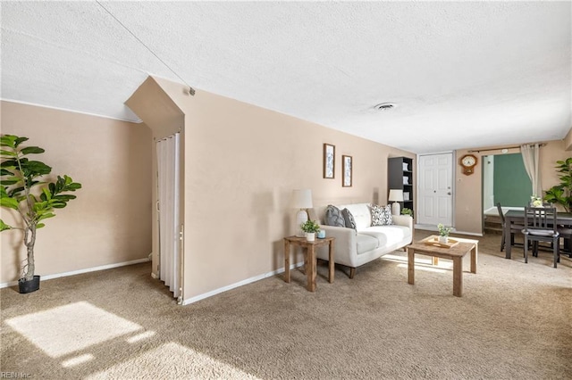 living room with a textured ceiling and carpet