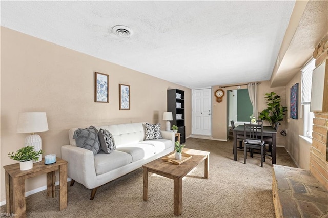 carpeted living room with a textured ceiling