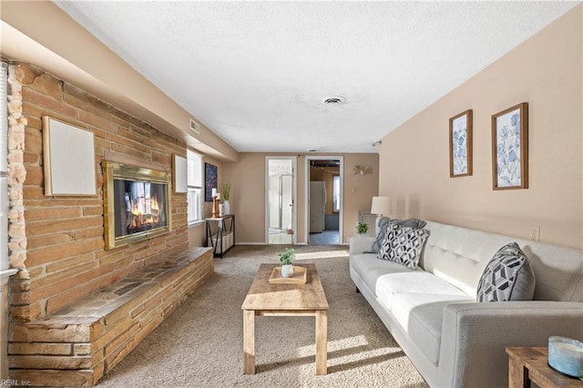 living room featuring carpet and a fireplace