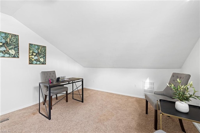 carpeted office space featuring vaulted ceiling