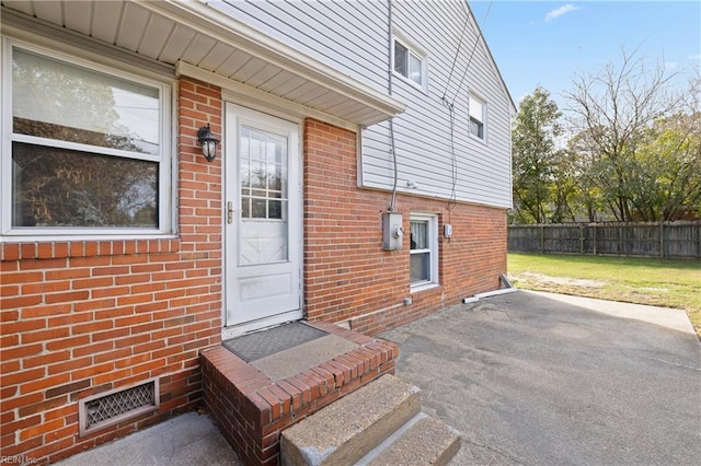 entrance to property with a patio