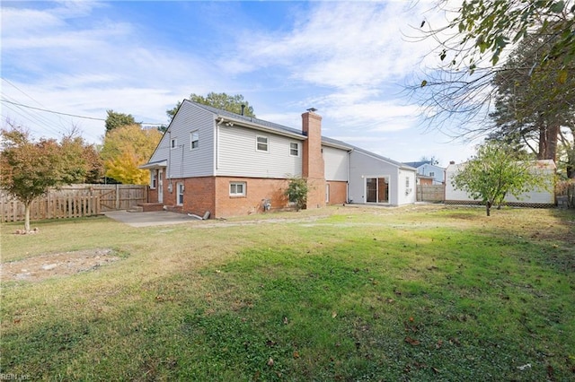 back of property with a patio and a yard