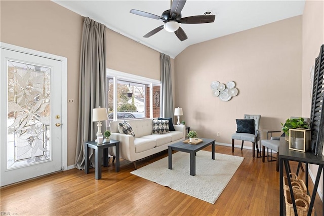 living room featuring lofted ceiling, wood-type flooring, and ceiling fan