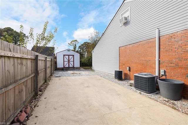 exterior space featuring cooling unit, a storage shed, and a patio