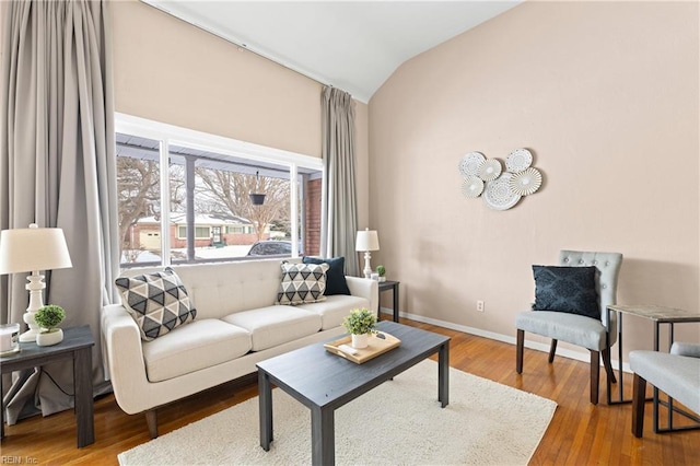 living room featuring hardwood / wood-style flooring and vaulted ceiling