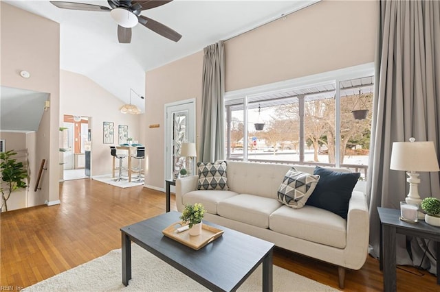 living room with vaulted ceiling, ceiling fan, and hardwood / wood-style floors