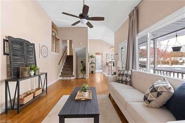 living room featuring wood-type flooring, lofted ceiling, and ceiling fan