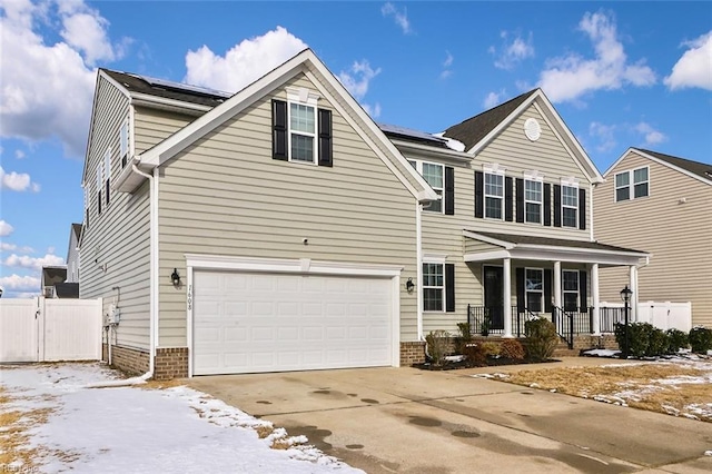 front of property with a porch, a garage, and solar panels