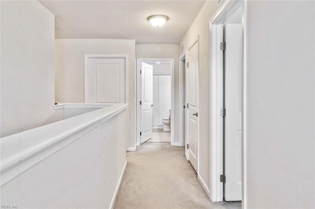 hallway with light colored carpet